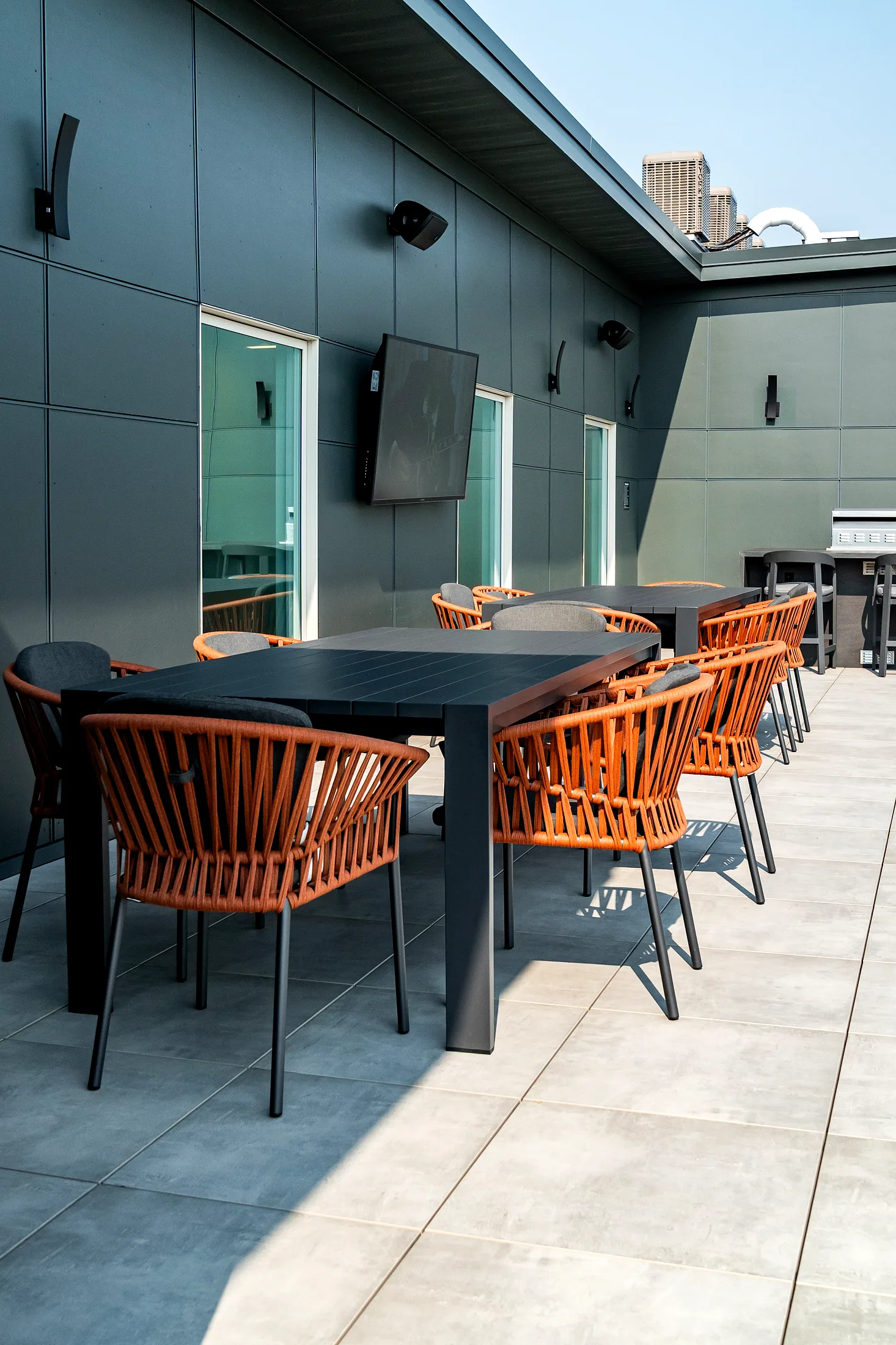 Dining table with terracotta rope chairs on the north terrace at Five85West