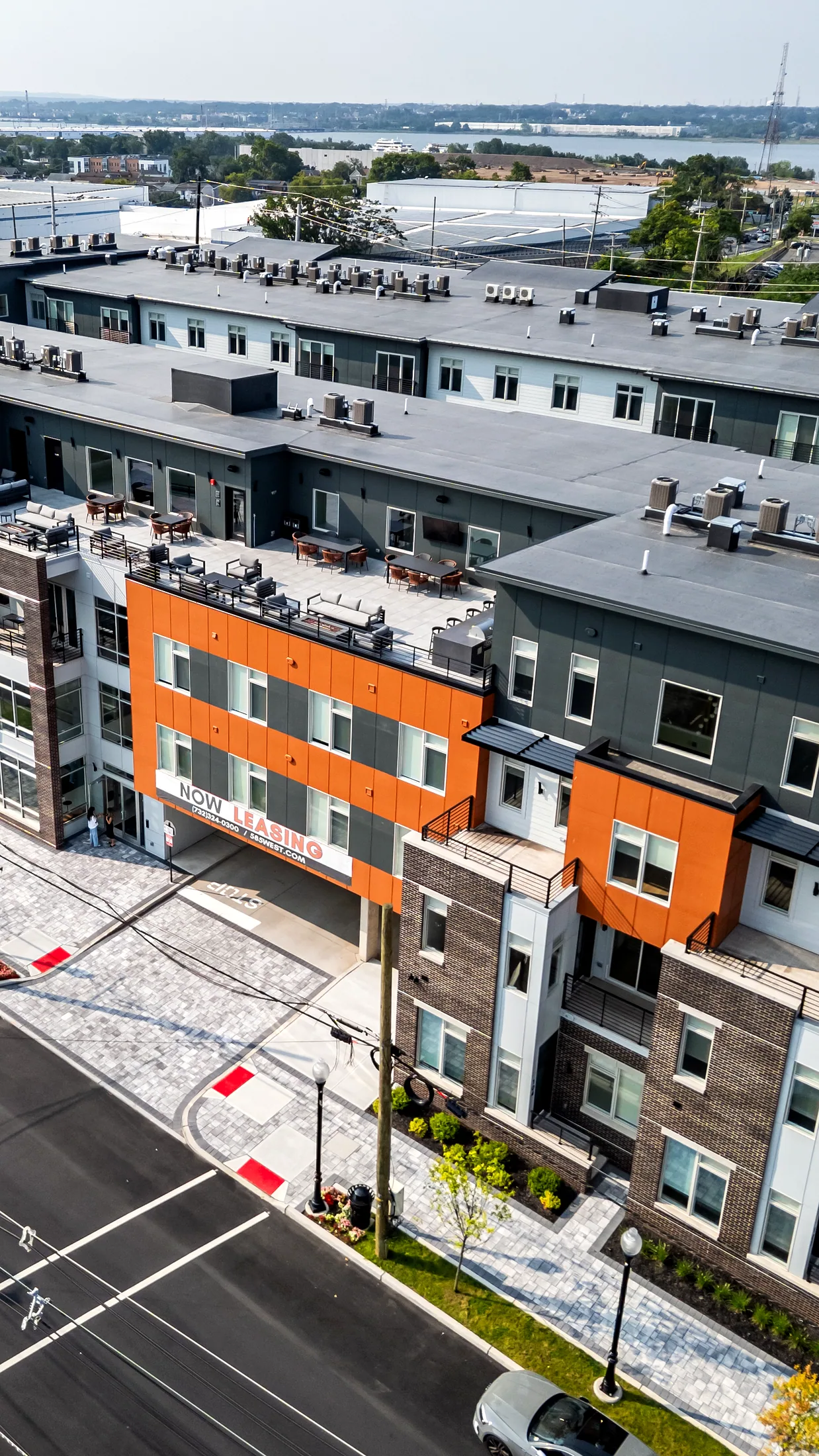 The townhome row at Five85West seen from above, with orange panels and private entrances